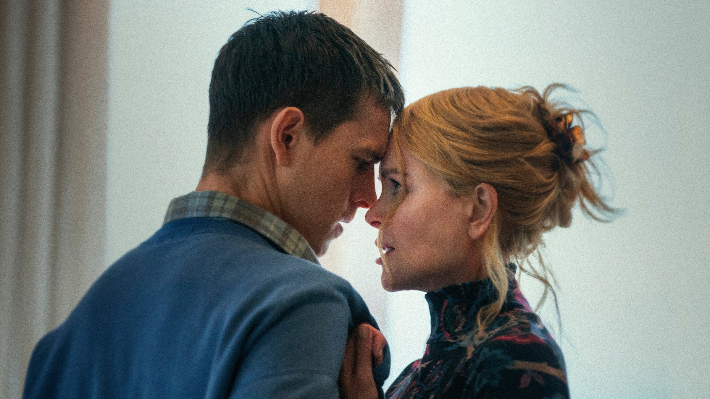 Harris Dickinson and Nicole Kidman embracing with their eyes locked in Babygirl.
