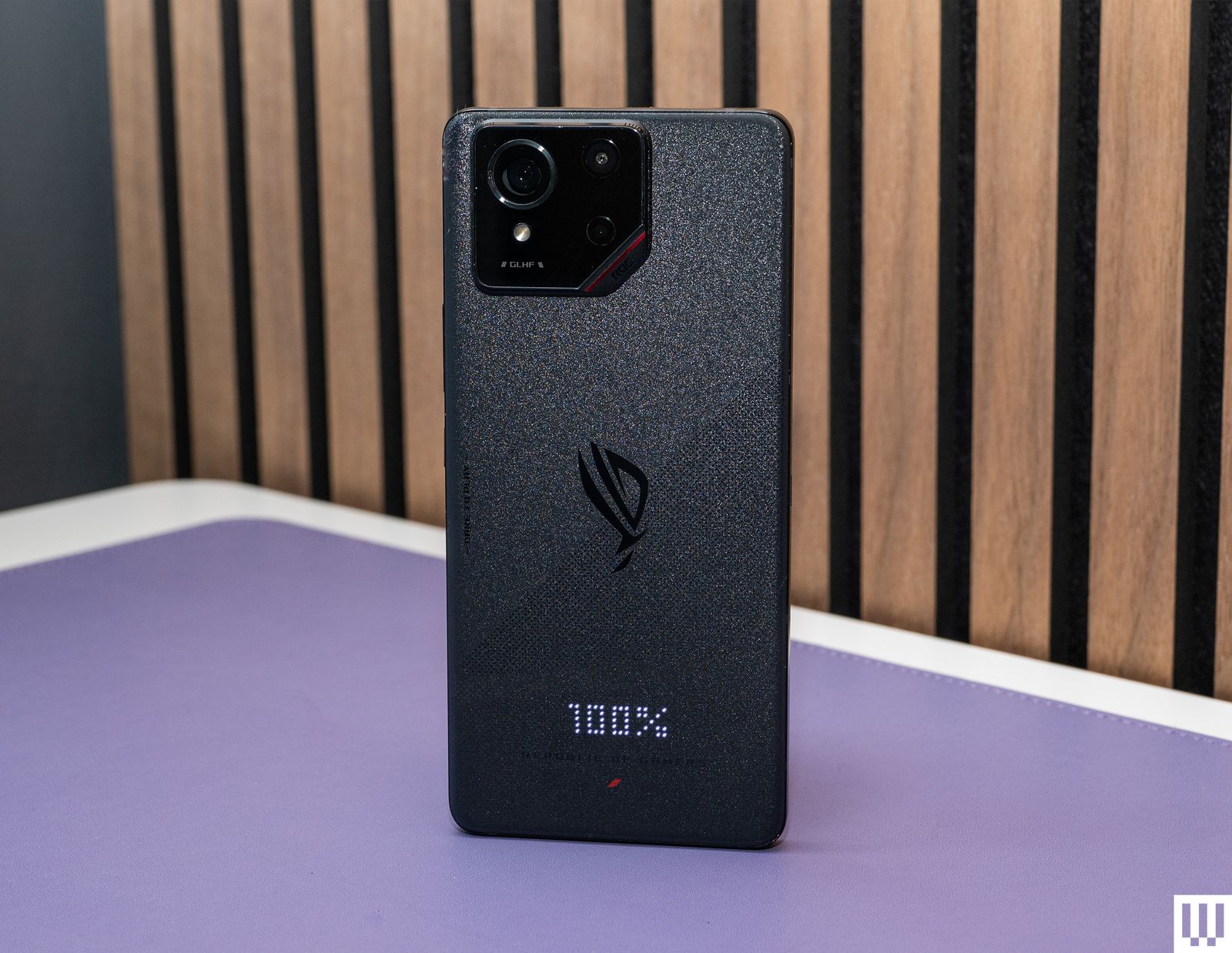 Rear view of the Asus R.O.G. Phone 9 a slim black mobile phone with a camera on the back and small digital display...