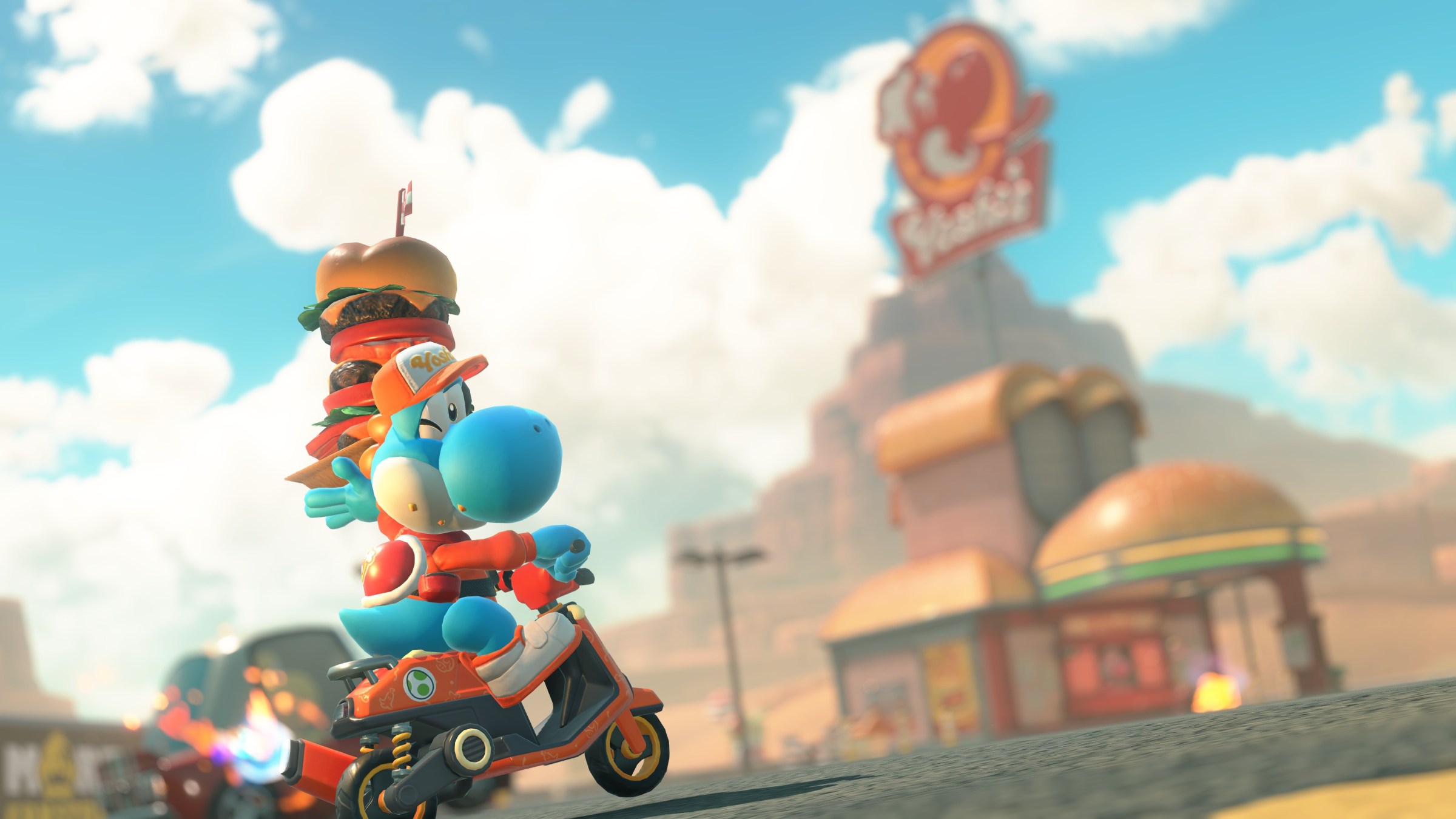 A blue Yoshi holds up a stacked burger outside a Yoshi’s drive-in in Mario Kart World