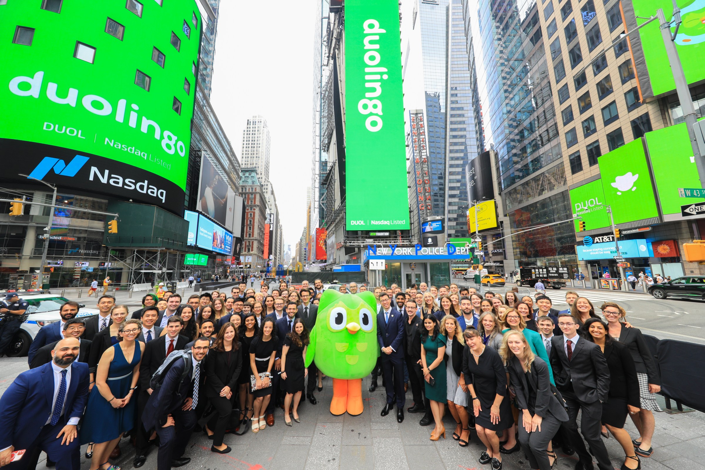 Duo the owl surrounded by people at Duolingo’s IPO launch in Times Square.